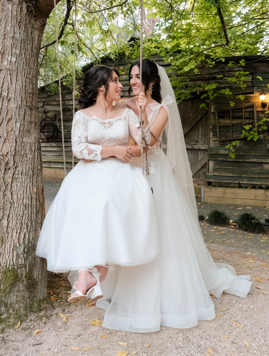 brides on swing at Log Cabin Ranch wedding