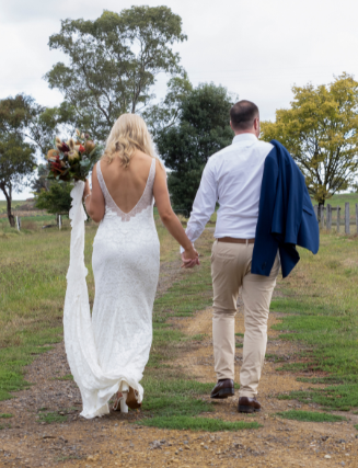 couple walking hand in hand after wedding at Yering Farm Wines