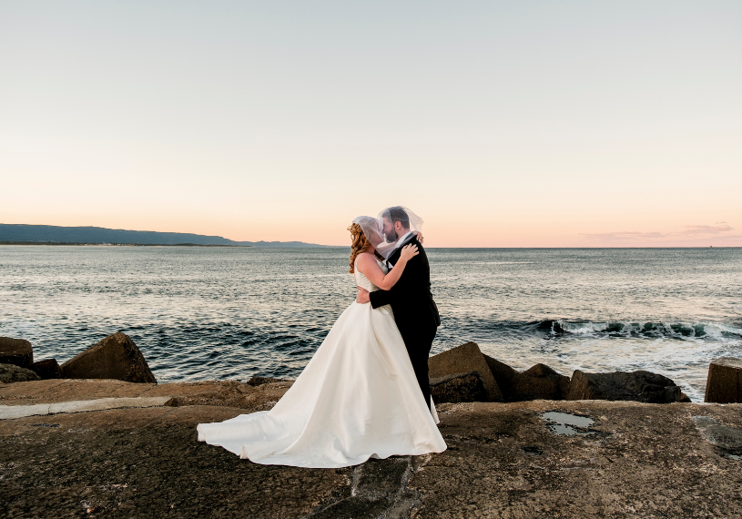 1 bride and groom dancing at sunset at Wollongong lighthouse captured by Sydney Wedding Photographer